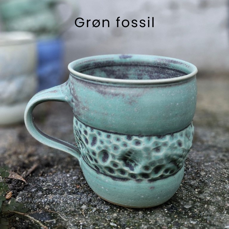 Grøn fossilkop med hank